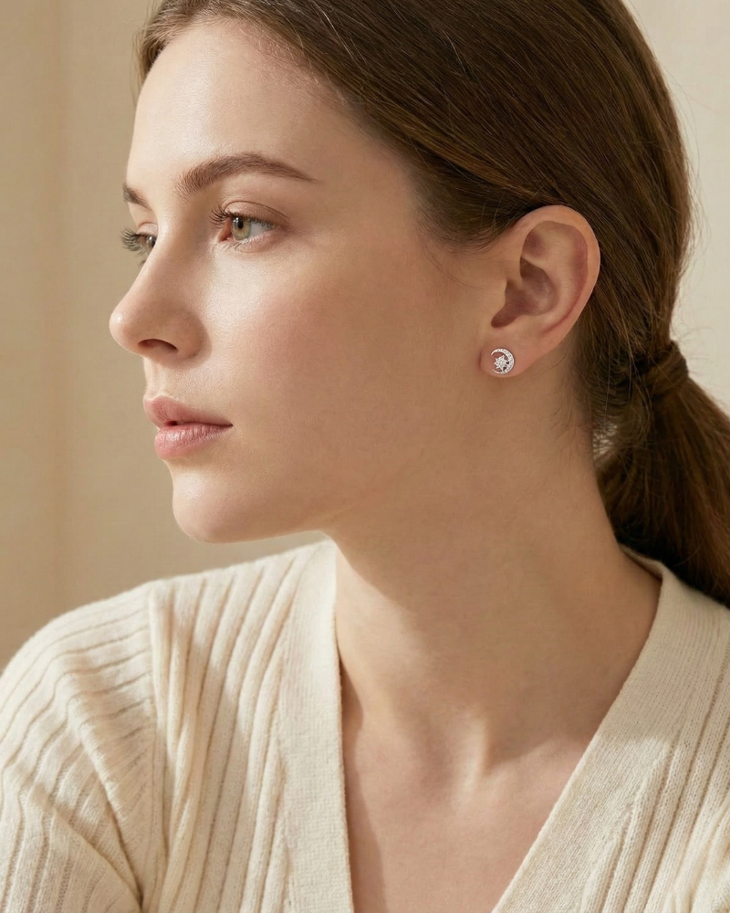 Woman wearing a diamond earring with a neutral background
