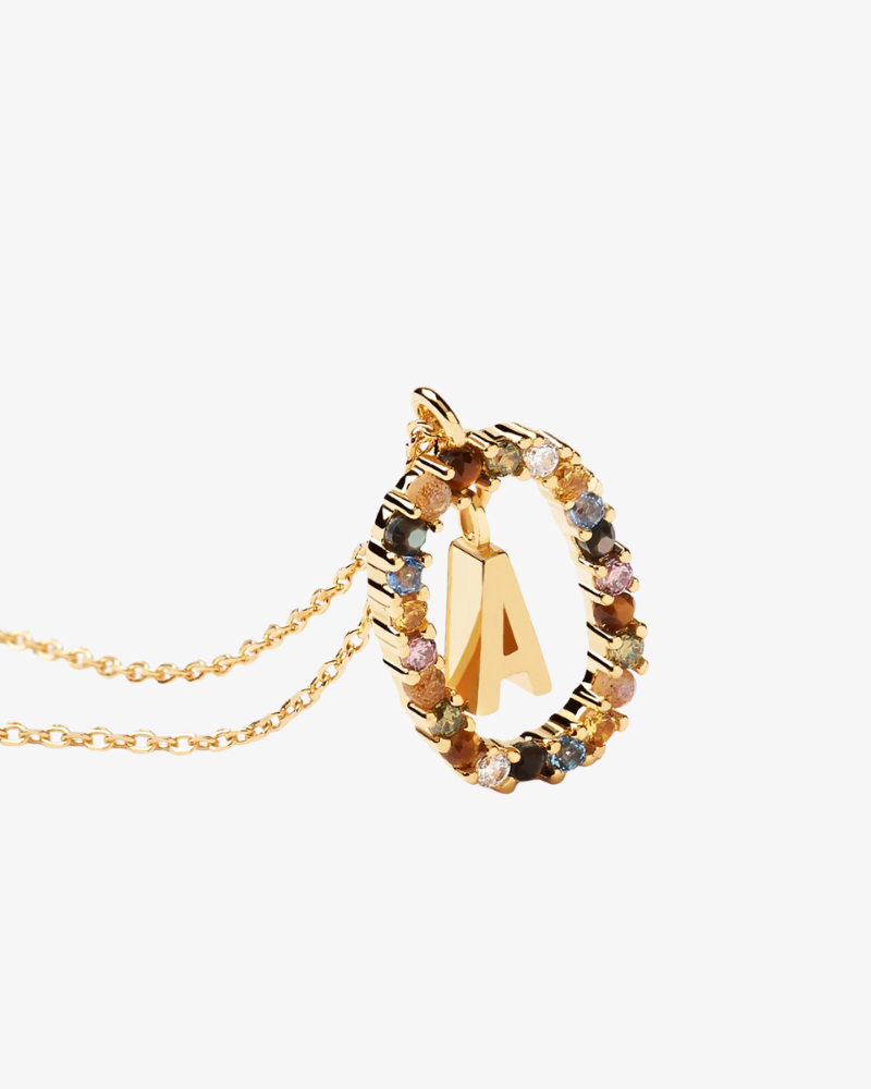 Gold necklace with a circular pendant featuring the letter 'A' on a white background