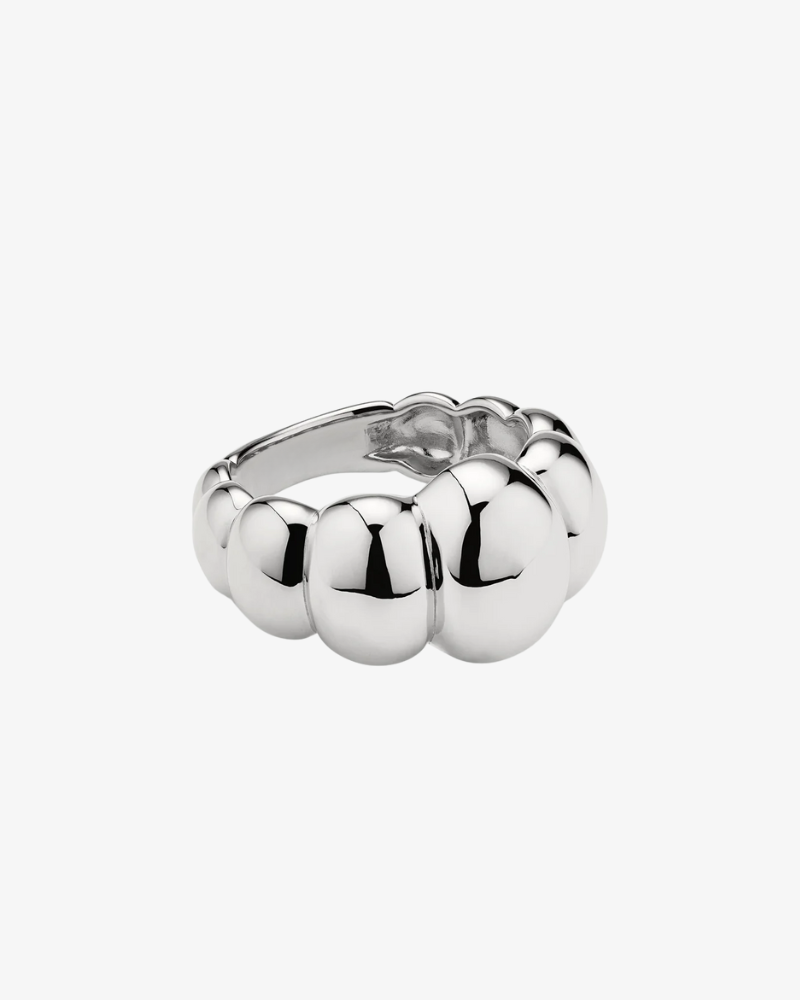 Silver ring with bubble design on a white background