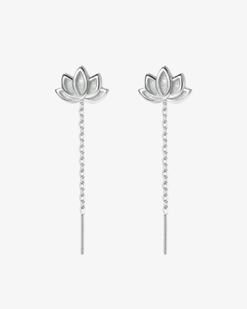 Silver lotus flower earrings on a white background